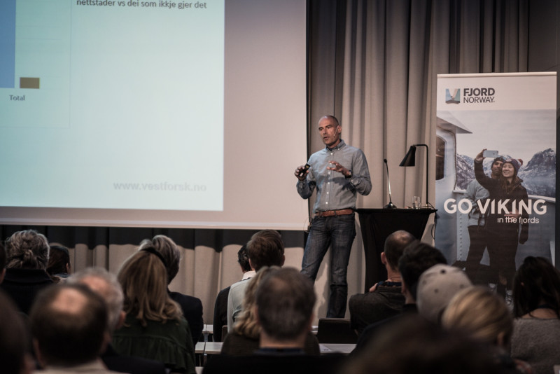 Mann på podium på konferanse